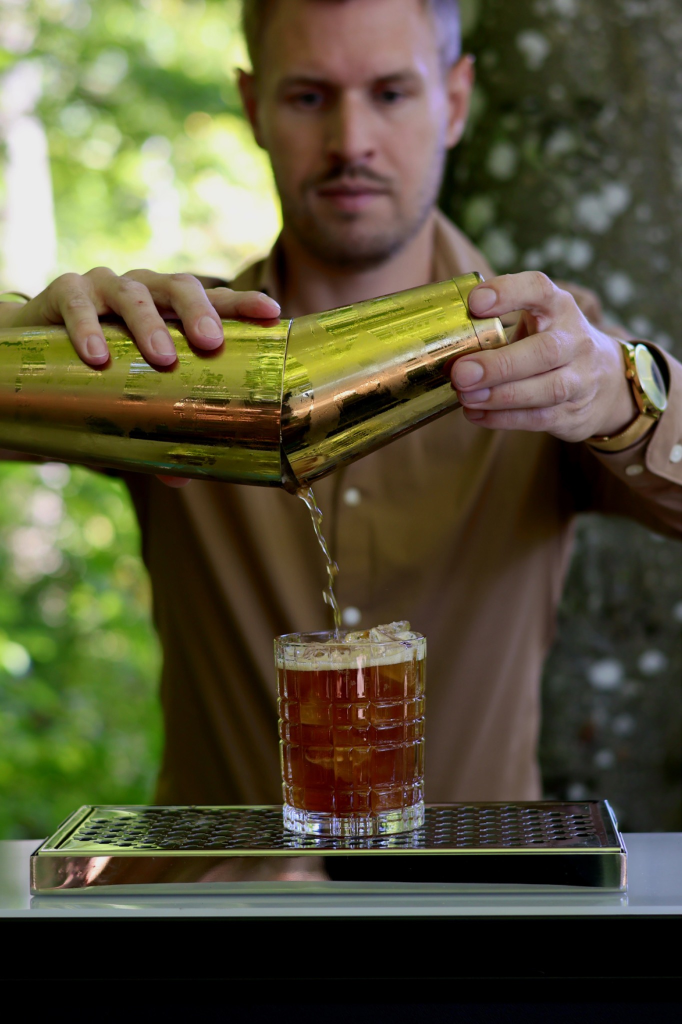 Bartender pouring a cocktail from a shaker