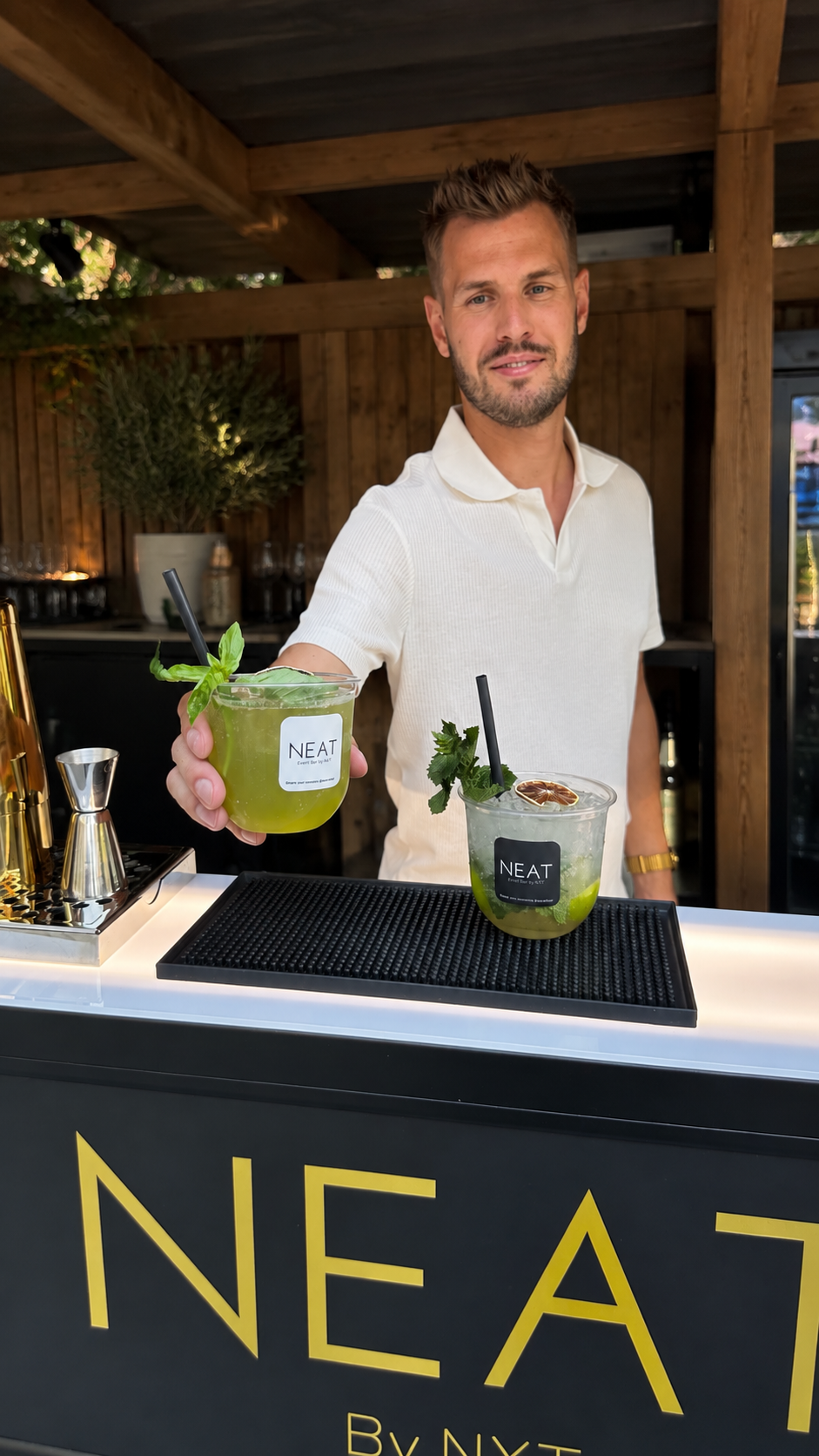 NEAT bartender serving branded drinks